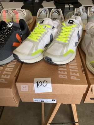 several pairs of running shoes are on a table in a store