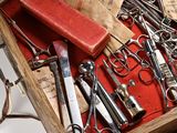 many different types of scissors in a wooden box