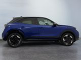 a blue honda hrx is parked in a garage
