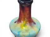 a vase that is sitting on a white surface