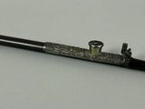 a black and gold pen sitting on top of a white table