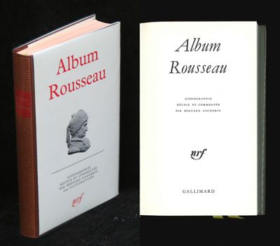 an open book sitting next to a closed book on top of a table