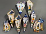 several pieces of porcelain art are displayed on a gray surface
