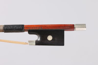 the bow is made of wood and has a black handle and a silver tip