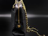 a black purse with a gold chain hanging from it