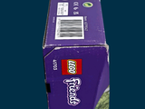 a purple box of toothpaste sitting on a blue surface
