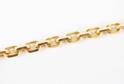 a close up of a gold chain on a white background