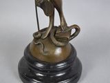 bronze statue of a woman on a horse holding a staff