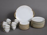 a lot of white plates and cups on the table