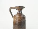 a brown vase with a handle on a white background