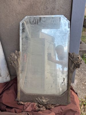 a mirror that is sitting on the ground next to a building