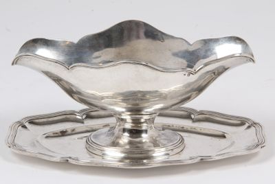 a silver plate with a flower shaped bowl on it