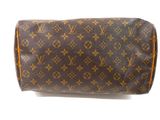 a close up of a brown and tan louis vuittou toilet bag