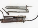 two old tools that are laying on a white surface