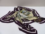 purple and white square scarf with gold chains on it on a white surface