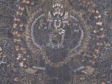 an image of a black and gold tapestry with a picture of a woman