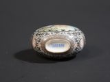a small vase that is sitting on a black surface