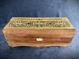 an old wooden box with a decorative design on it