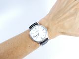 a woman ' s hand with a watch on her wrist