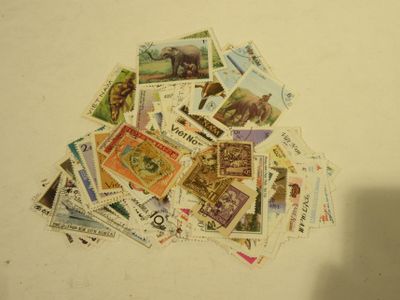 a pile of postage stamps on a white surface