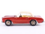 a red toy car that is sitting on a white surface