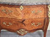 a marble top chest of drawers on display in a room