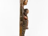 a wooden statue of a woman holding a child
