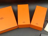 three orange boxes are sitting next to each other on a table