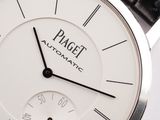 a close up of a white watch with black hands