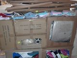 a large pile of clothes sitting on top of a carton