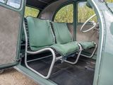 two seats in the back of an old green car