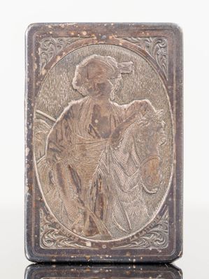 an antique silver plate with a picture of a man on a horse