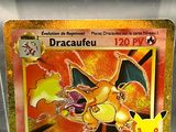 a pokemon card in a plastic container on a table