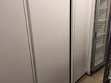 three refrigerators in a row in a kitchen