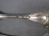 a silver spoon and a silver spoon on a table
