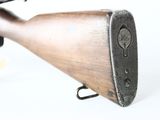 an old rifle with a wooden barrel on a white background