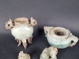 three pieces of pottery sitting on top of a table next to each other