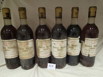 six bottles of wine are lined up in a row on a table