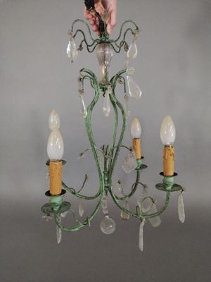 a person that is holding a chandelier in their hand