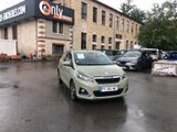 a green car parked in front of a building