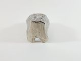a close up of a silver elephant figurine on a white surface