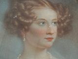 portrait of a woman in a white dress with a pearl necklace and pearl earrings