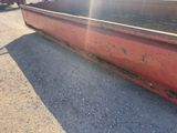 a large red container sitting on the side of the road