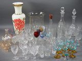 a lot of glasses and vases sitting on a table