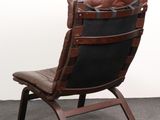 brown leather lounge chair with black leather seat and foot rest