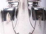 a silver tea pot that is sitting on a table