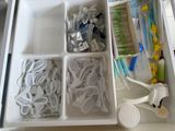 a drawer with toothbrushes, toothpaste, toothpaste, toothpaste, and toothbrushes in it