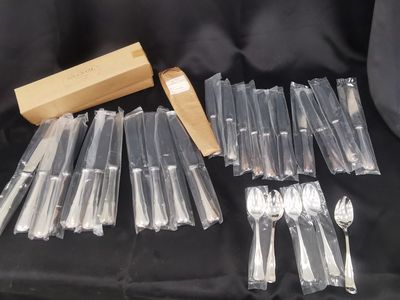a lot of forks and spoons sitting on a table
