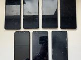 four black iphones are sitting next to each other on a table