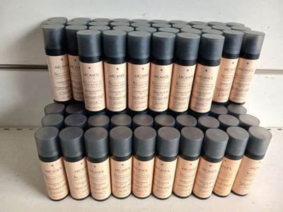 a lot of bottles of makeup sitting on a table